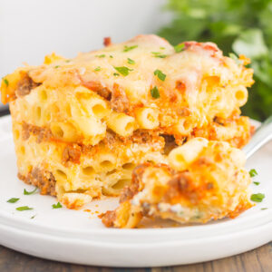 This Easy Baked Ziti is made with simple ingredients, full of flavor, and ready in less than an hour. Loaded with an easy meat sauce, tender pasta, and three types of cheese, this comfort dish is sure to be a dinnertime crowd-pleaser!