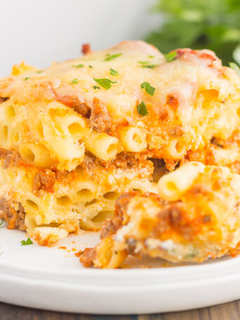This Easy Baked Ziti is made with simple ingredients, full of flavor, and ready in less than an hour. Loaded with an easy meat sauce, tender pasta, and three types of cheese, this comfort dish is sure to be a dinnertime crowd-pleaser!
