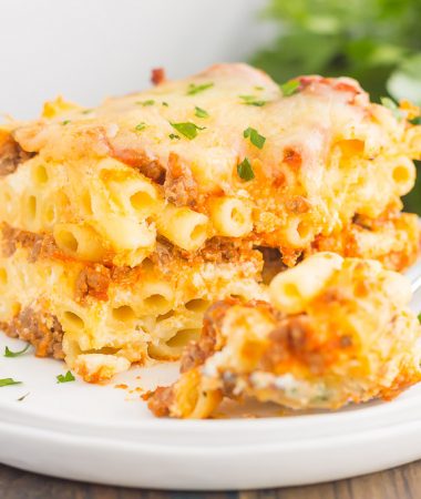 This Easy Baked Ziti is made with simple ingredients, full of flavor, and ready in less than an hour. Loaded with an easy meat sauce, tender pasta, and three types of cheese, this comfort dish is sure to be a dinnertime crowd-pleaser!