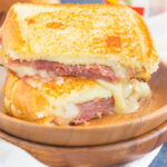 This Prosciutto, Raspberry and Brie Grilled Cheese is loaded with fresh slices of prosciutto, raspberry jam, brie and mozzarella cheeses. Grilled until golden and melty, this sandwich is the perfect comfort dish!