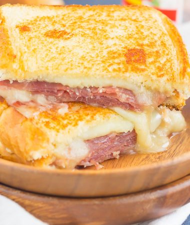 This Prosciutto, Raspberry and Brie Grilled Cheese is loaded with fresh slices of prosciutto, raspberry jam, brie and mozzarella cheeses. Grilled until golden and melty, this sandwich is the perfect comfort dish!