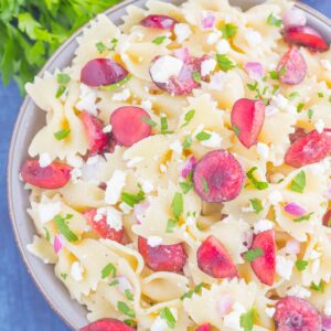 This Cherry Balsamic Pasta Salad is packed with fresh cherries, red onion, and feta cheese, all topped with a light white balsamic dressing. Easy to make and bursting with flavor, this salad is the perfect summer dish to enjoy all season long!
