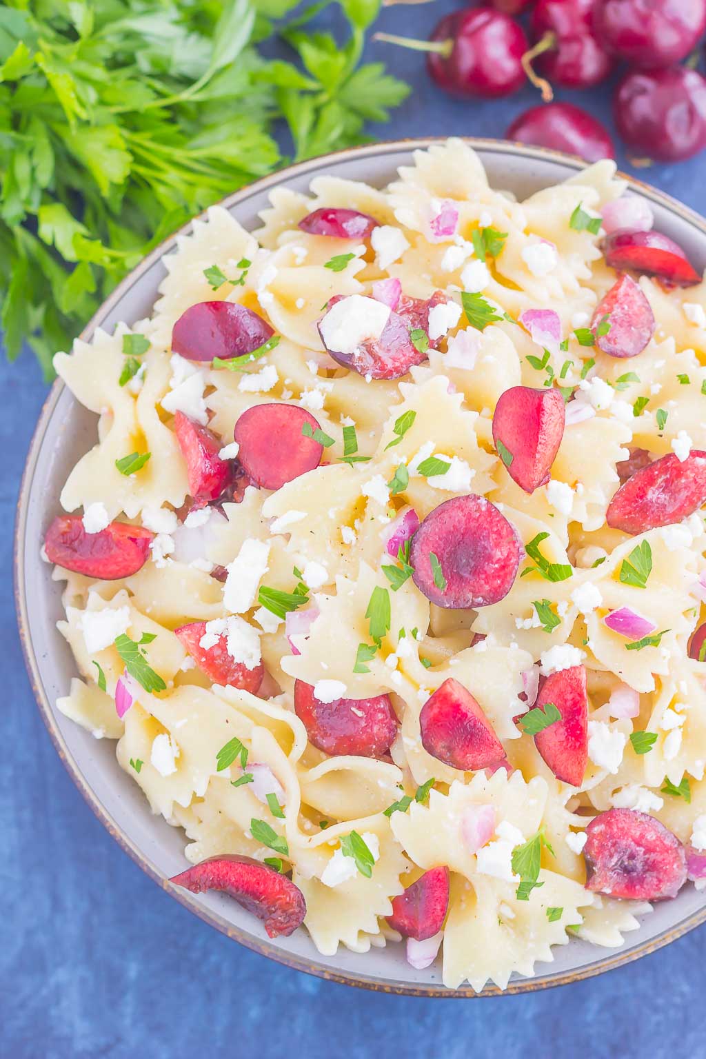 This Cherry Balsamic Pasta Salad is packed with fresh cherries, red onion, and feta cheese, all topped with a light white balsamic dressing. Easy to make and bursting with flavor, this salad is the perfect summer dish to enjoy all season long!