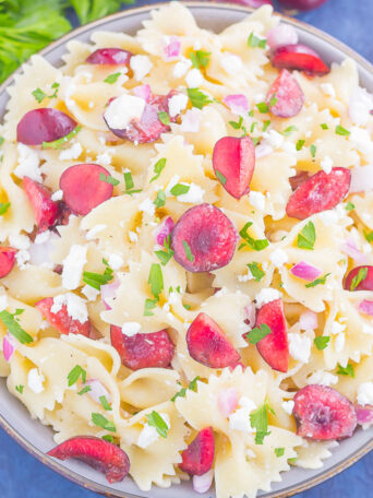 This Cherry Balsamic Pasta Salad is packed with fresh cherries, red onion, and feta cheese, all topped with a light white balsamic dressing. Easy to make and bursting with flavor, this salad is the perfect summer dish to enjoy all season long!