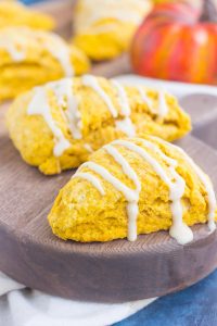 two pumpkin scones drizzled with a maple glaze