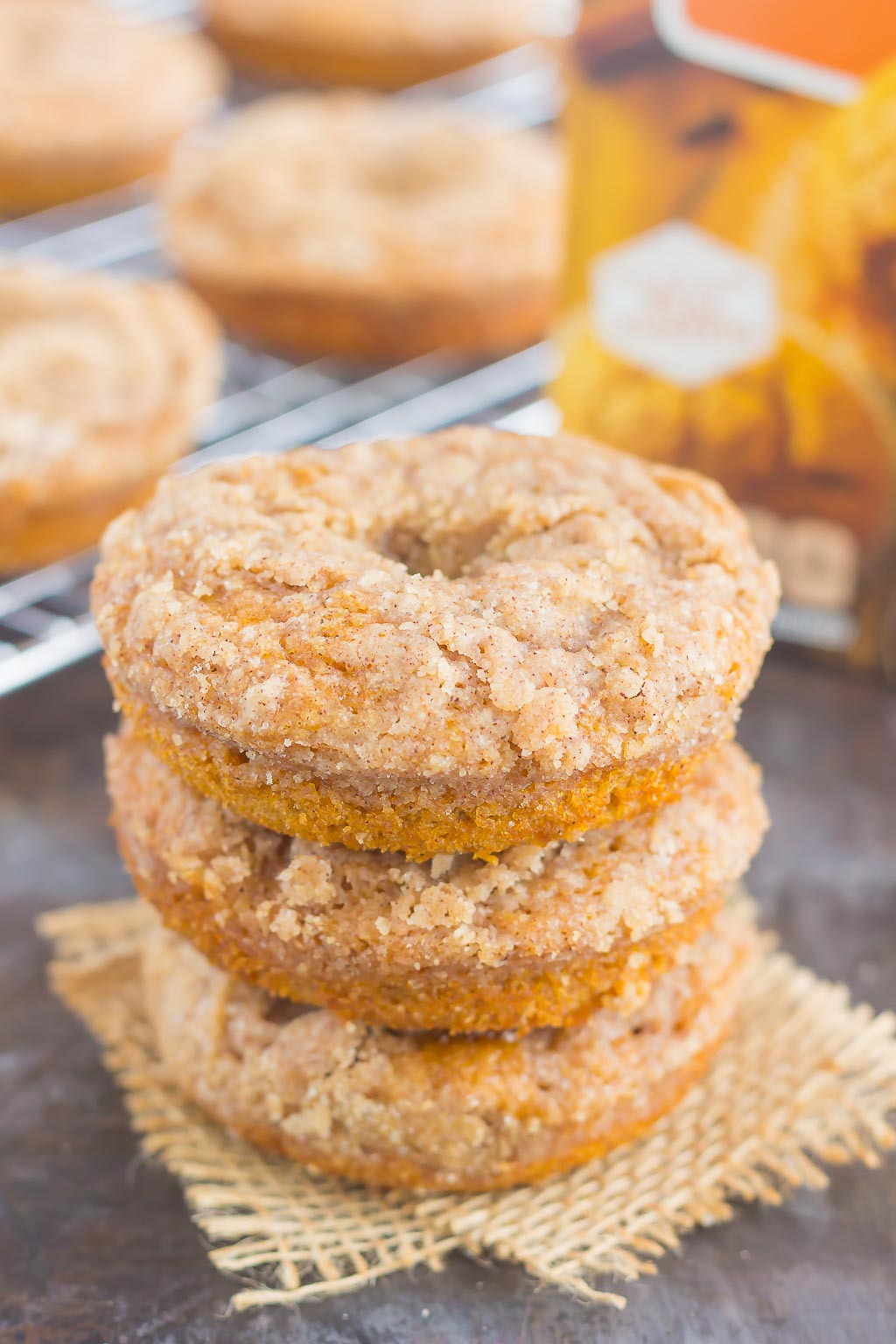 These Baked Pumpkin Streusel Donuts are soft, fluffy, and bursting with pumpkin. Filled with cozy fall flavors and topped with a sweet cinnamon streusel, this easy treat is the perfect fall breakfast or dessert! #pumpkin #pumpkindonuts #bakeddonuts #donutrecipes #fallrecipe #pumpkinrecipe #fallbreakfast #falldessert #pumpkinbreakfast #pumpkindessert #breakfast #dessert