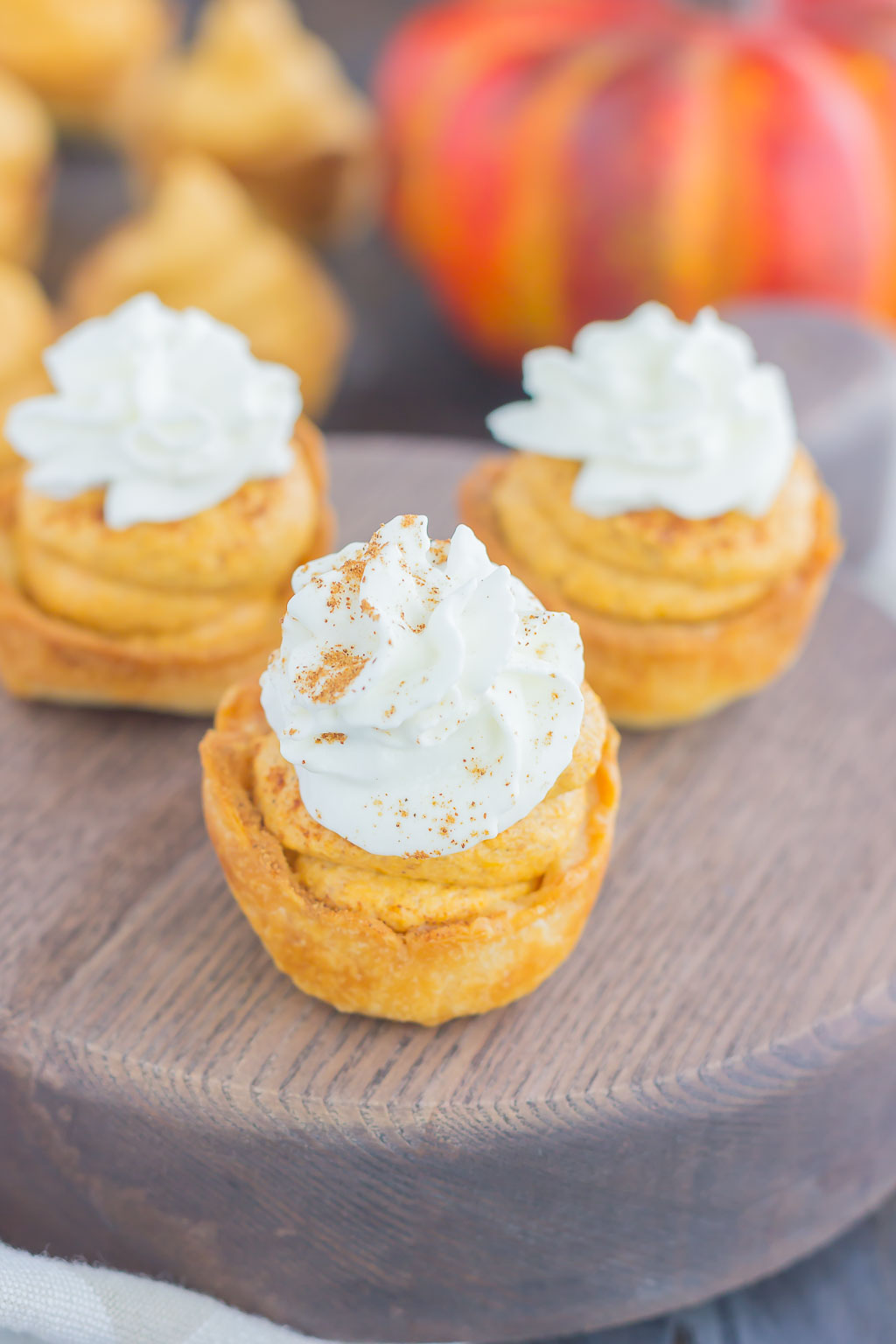 These Whipped Pumpkin Pie Bites are perfectly portable, poppable, and so easy to make. With just a few ingredients and hardly any prep time, you can have your pumpkin pie in bite-sized form! #pumpkin #pumpkinpie #pumpkinpiebites #pumpkinbites #piebites #pumpkinrecipe #fallrecipes #falldessert #pumpkindessert #dessert