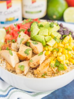 Skip the takeout and make your own Easy Chicken Burrito Bowl at home! It's loaded with juicy chicken, cilantro lime rice, black beans, corn, fresh tomatoes, and avocado. Drizzled with a soy sauce marinade and ready in no time, this meal is sure to become a family favorite!