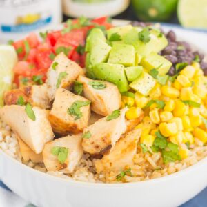 Skip the takeout and make your own Easy Chicken Burrito Bowl at home! It's loaded with juicy chicken, cilantro lime rice, black beans, corn, fresh tomatoes, and avocado. Drizzled with a soy sauce marinade and ready in no time, this meal is sure to become a family favorite!