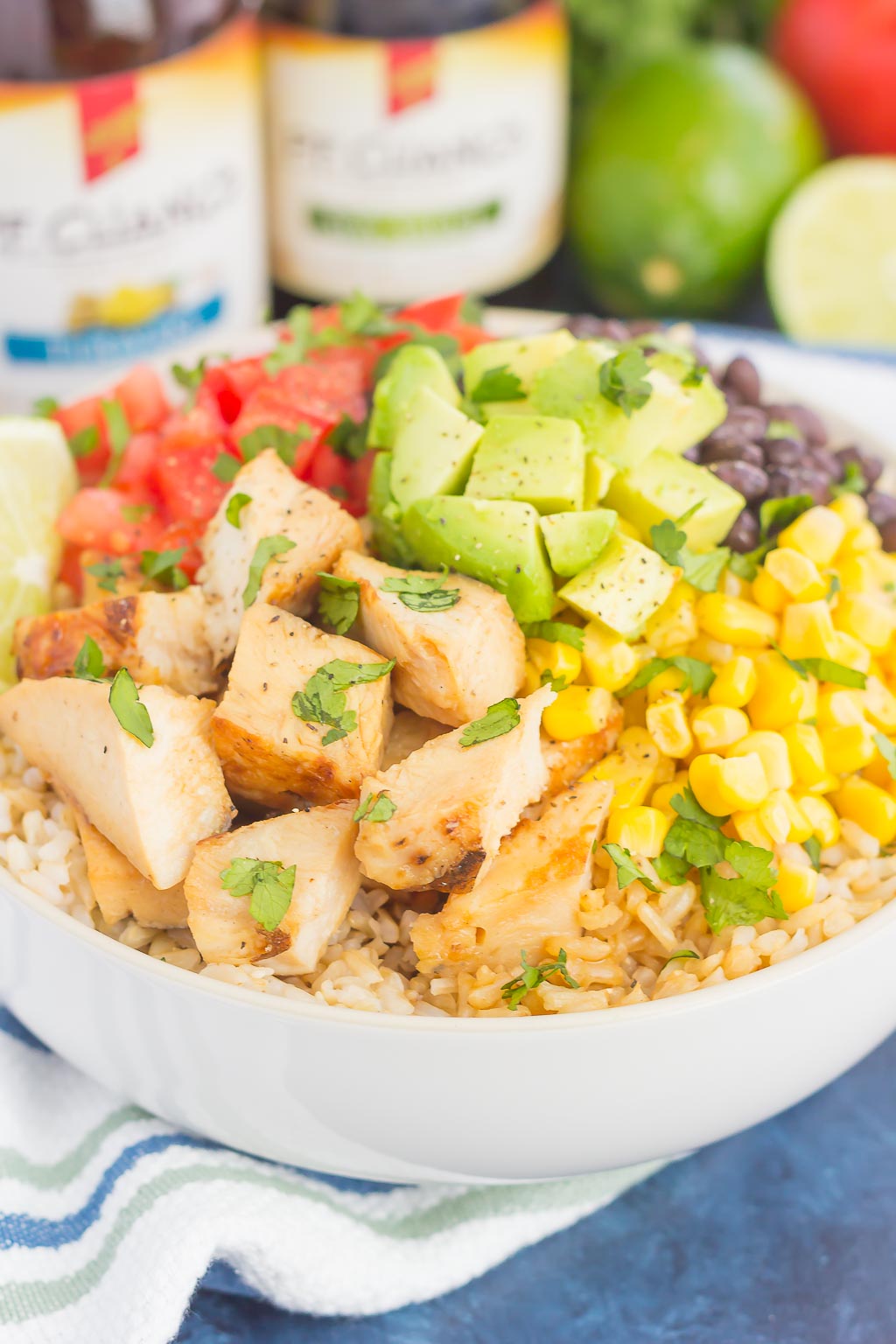 Skip the takeout and make your own Easy Chicken Burrito Bowl at home! It's loaded with juicy chicken, cilantro lime rice, black beans, corn, fresh tomatoes, and avocado. Drizzled with a soy sauce marinade and ready in no time, this meal is sure to become a family favorite!