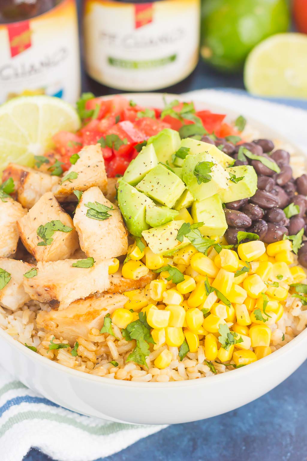 homemade chicken burrito bowl topped with diced avocado, corn, salsa, and beans