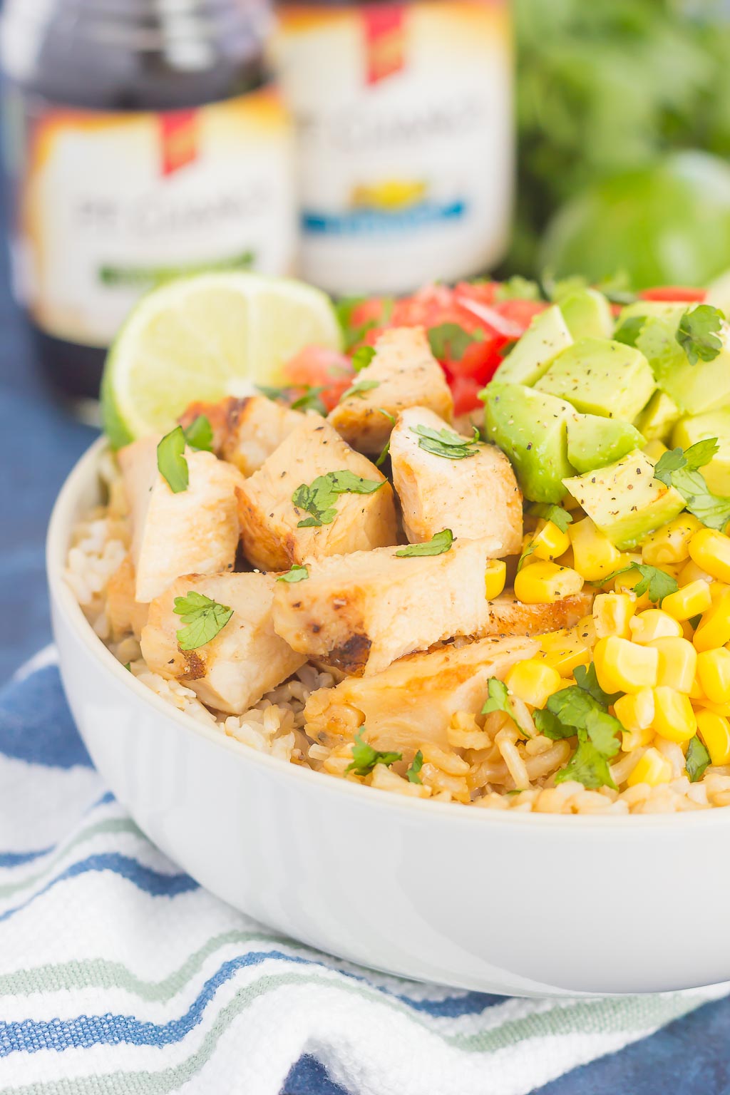 Skip the takeout and make your own Easy Chicken Burrito Bowl at home! It's loaded with juicy chicken, cilantro lime rice, black beans, corn, fresh tomatoes, and avocado. Drizzled with a soy sauce marinade and ready in no time, this meal is sure to become a family favorite!