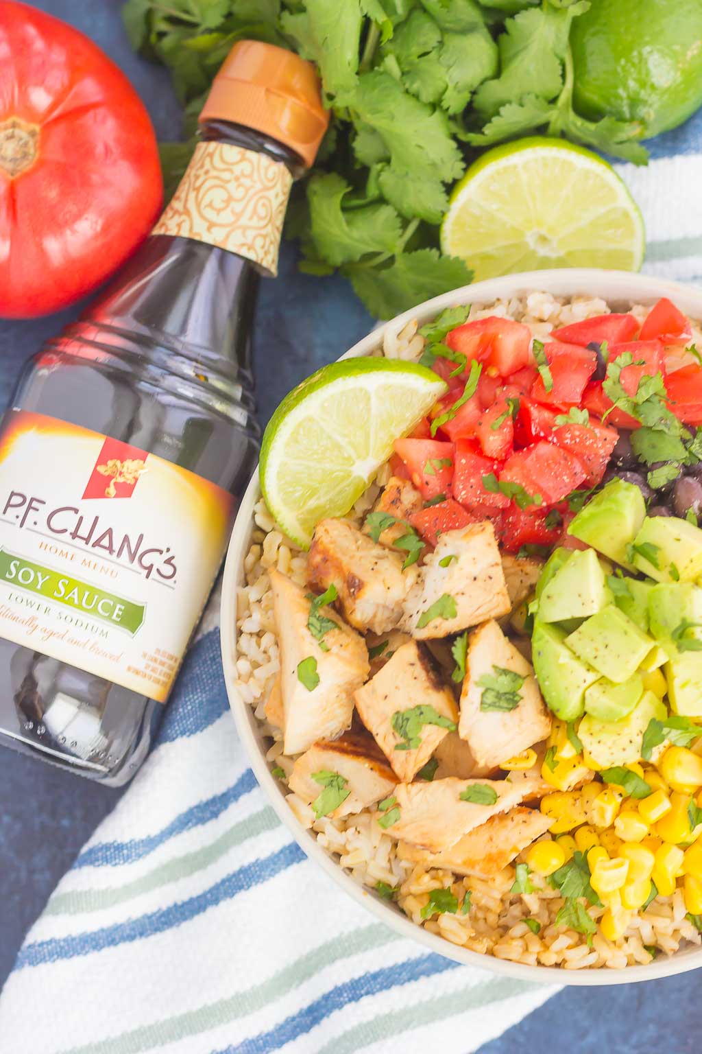 Skip the takeout and make your own Easy Chicken Burrito Bowl at home! It's loaded with juicy chicken, cilantro lime rice, black beans, corn, fresh tomatoes, and avocado. Drizzled with a soy sauce marinade and ready in no time, this meal is sure to become a family favorite!