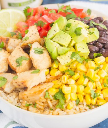 Skip the takeout and make your own Easy Chicken Burrito Bowl at home! It's loaded with juicy chicken, cilantro lime rice, black beans, corn, fresh tomatoes, and avocado. Drizzled with a soy sauce marinade and ready in no time, this meal is sure to become a family favorite!