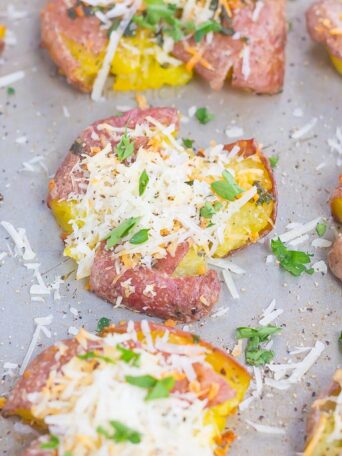 These Garlic Parmesan Smashed Potatoes are crispy on the outside, tender on the inside, and loaded with flavor. A savory garlic butter mixture coats the potatoes and then they're roasted to perfection, with a sprinkling of Parmesan cheese. Easy to make and even better to eat, this is sure to become a favorite side for dinner!