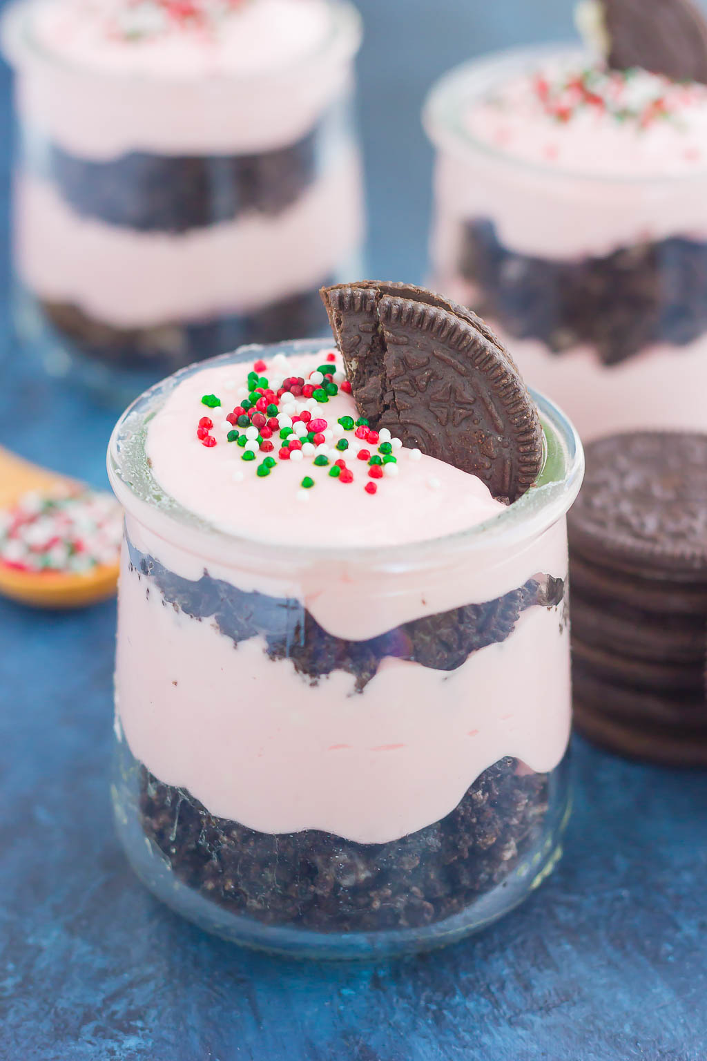 This No Bake Peppermint Oreo Cheesecake features a sweet and creamy peppermint cheesecake batter that requires no oven. A rich, Oreo cookie crust and festive sprinkles make this cheesecake perfect for the holidays! #cheesecake #nobakecheesecake #peppermintcheesecake #oreocheesecake #christmasdessert #holidaydessert #dessert