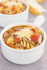 a white soup bowl with one pot lasagna soup in it