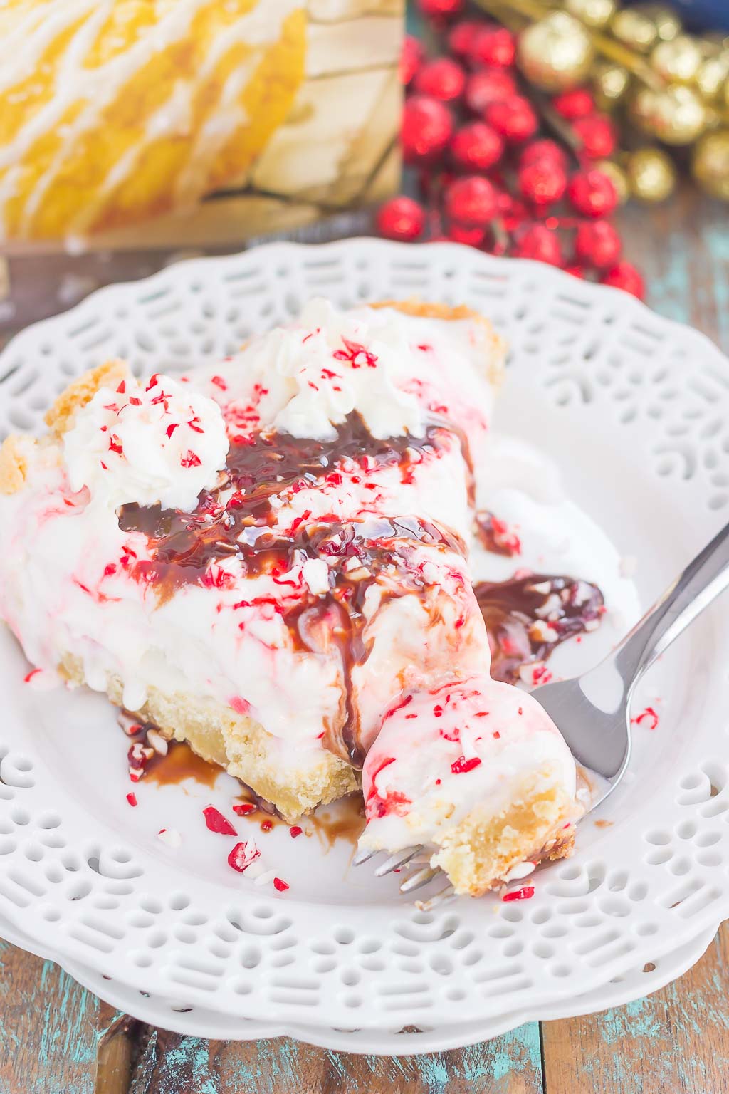 This Peppermint Sugar Cookie Ice Cream Pie is an easy dessert that's full of holiday flavors. A buttery sugar cookie crust envelopes creamy peppermint ice cream and is topped with crushed candy canes. It's a simple dessert that is sure to impress everyone this holiday season!
