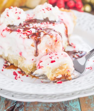 This Peppermint Sugar Cookie Ice Cream Pie is an easy dessert that's full of holiday flavors. A buttery sugar cookie crust envelopes creamy peppermint ice cream and is topped with crushed candy canes. It's a simple dessert that is sure to impress everyone this holiday season!