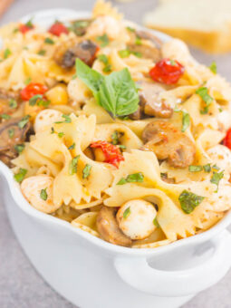 This Roasted Mushroom and Tomato Pasta Salad is a flavorful dish that comes together in minutes. Fresh mushrooms and cherry tomatoes are roasted until tender and then tossed with chickpeas, mozzarella and pasta in a light, white balsamic dressing. Bursting with flavor and perfect for a light lunch or dinner, you'll be making this pasta salad all year long!