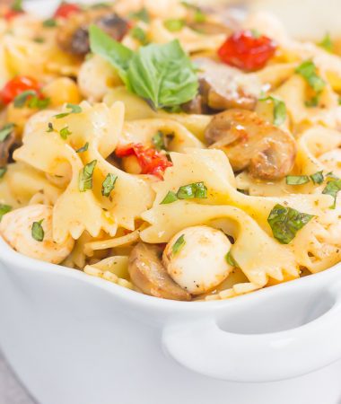 This Roasted Mushroom and Tomato Pasta Salad is a flavorful dish that comes together in minutes. Fresh mushrooms and cherry tomatoes are roasted until tender and then tossed with chickpeas, mozzarella and pasta in a light, white balsamic dressing. Bursting with flavor and perfect for a light lunch or dinner, you'll be making this pasta salad all year long!