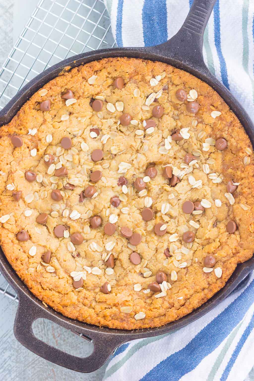 You won't be able to resist this warm, thick, and fudgy Peanut Butter Chocolate Chip Skillet Cookie. Packed with creamy peanut butter, hearty oats, and chocolate chips, this cookie is packed with flavor and is perfect when served with a big scoop of vanilla ice cream!