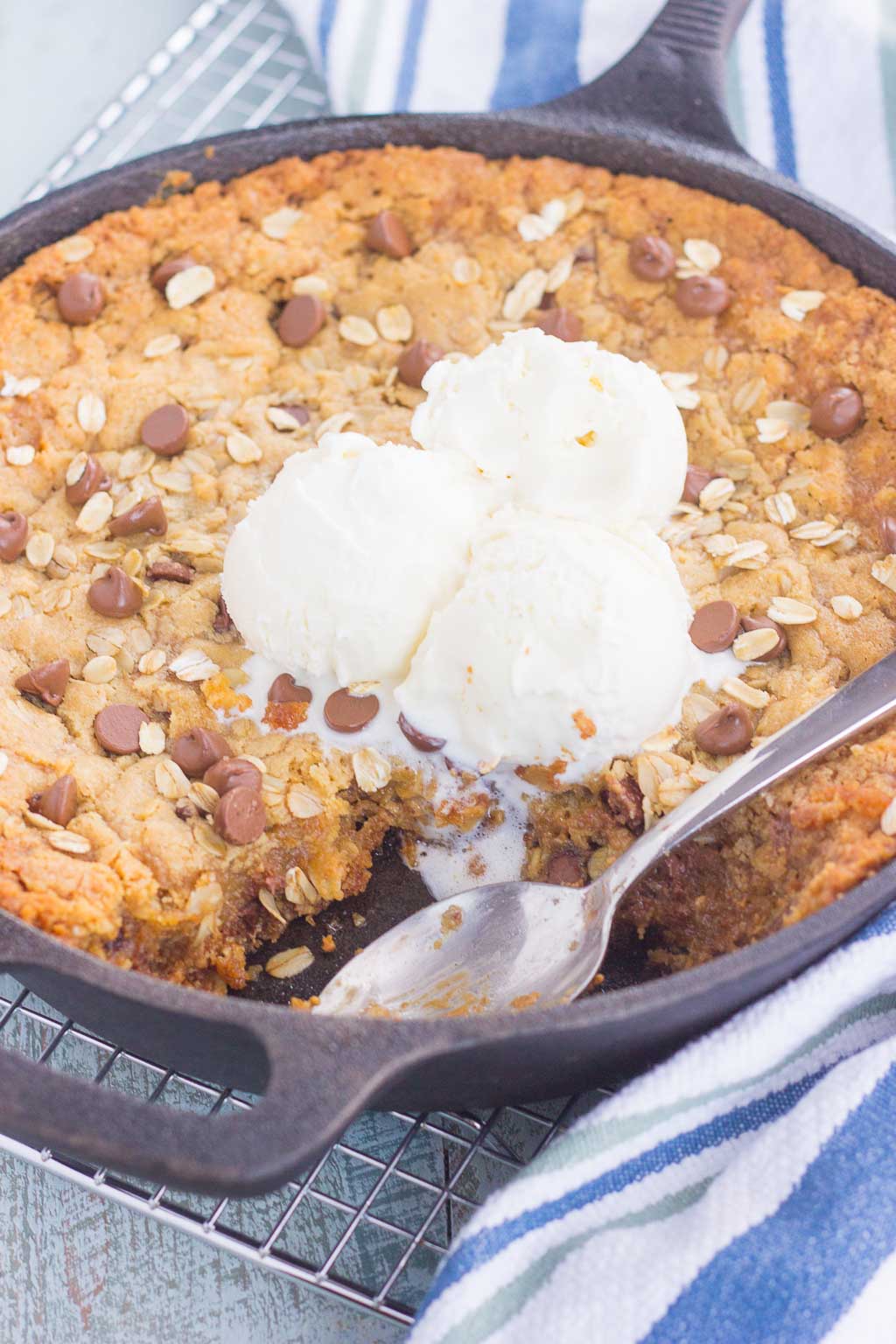 You won't be able to resist this warm, thick, and fudgy Peanut Butter Chocolate Chip Skillet Cookie. Packed with creamy peanut butter, hearty oats, and chocolate chips, this cookie is packed with flavor and is perfect when served with a big scoop of vanilla ice cream!