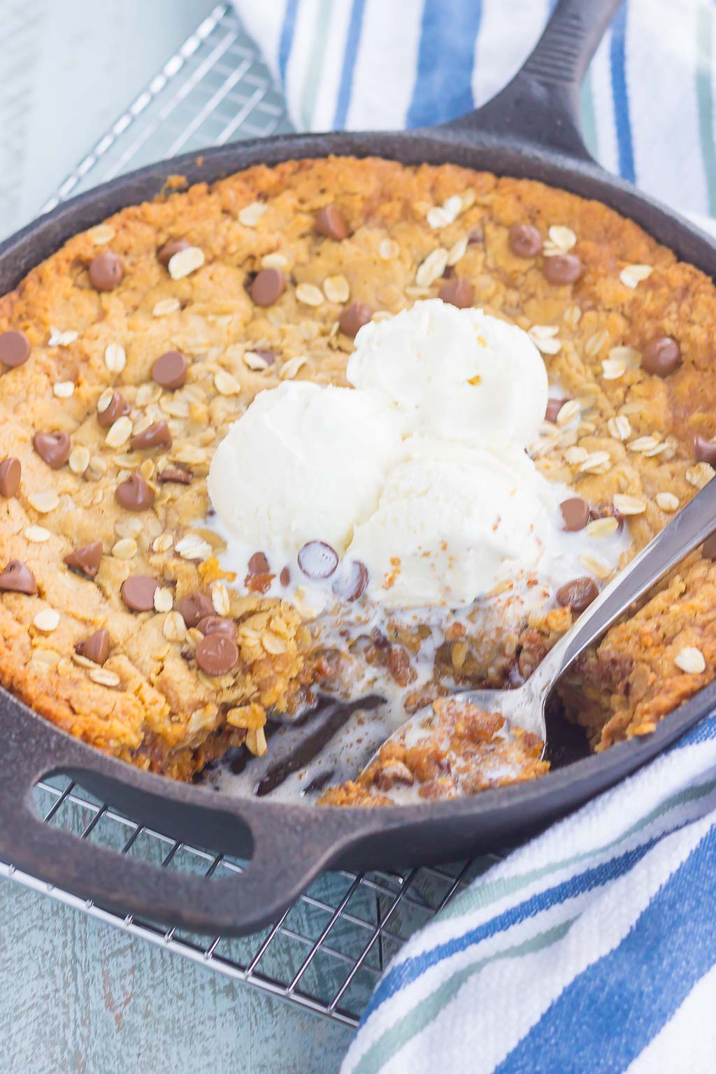 You won't be able to resist this warm, thick, and fudgy Peanut Butter Chocolate Chip Skillet Cookie. Packed with creamy peanut butter, hearty oats, and chocolate chips, this cookie is packed with flavor and is perfect when served with a big scoop of vanilla ice cream!