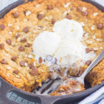 You won't be able to resist this warm, thick, and fudgy Peanut Butter Chocolate Chip Skillet Cookie. Packed with creamy peanut butter, hearty oats, and chocolate chips, this cookie is packed with flavor and is perfect when served with a big scoop of vanilla ice cream!