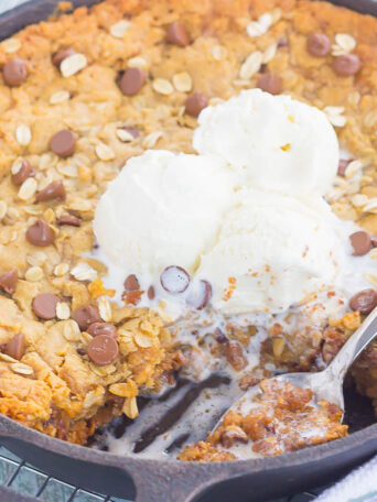 You won't be able to resist this warm, thick, and fudgy Peanut Butter Chocolate Chip Skillet Cookie. Packed with creamy peanut butter, hearty oats, and chocolate chips, this cookie is packed with flavor and is perfect when served with a big scoop of vanilla ice cream!