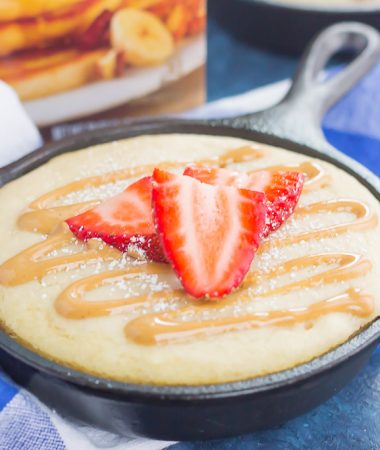 Peanut Butter and Jelly Baked Pancakes is a warm and cozy breakfast to get you going in the mornings. Fluffy, buttermilk pancake batter is swirled with sweet strawberry jelly and then baked in mini cast iron skillets. Drizzled with a sweet peanut butter syrup and topped with fresh strawberries, this easy breakfast is ready in less than 30 minutes and perfect for the whole family!