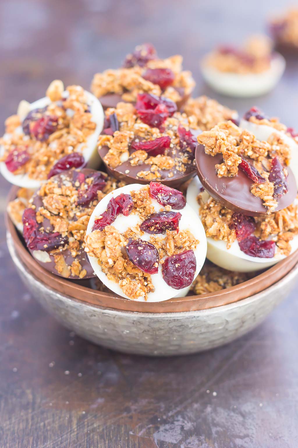 These Chocolate Cherry Granola Cups are the perfect bite for when you want something sweet. Smooth dark chocolate and creamy white chocolate cups are topped with crunchy granola and dried cherries. With no oven needed and ready in minutes, these cups make a delicious dessert or snack!