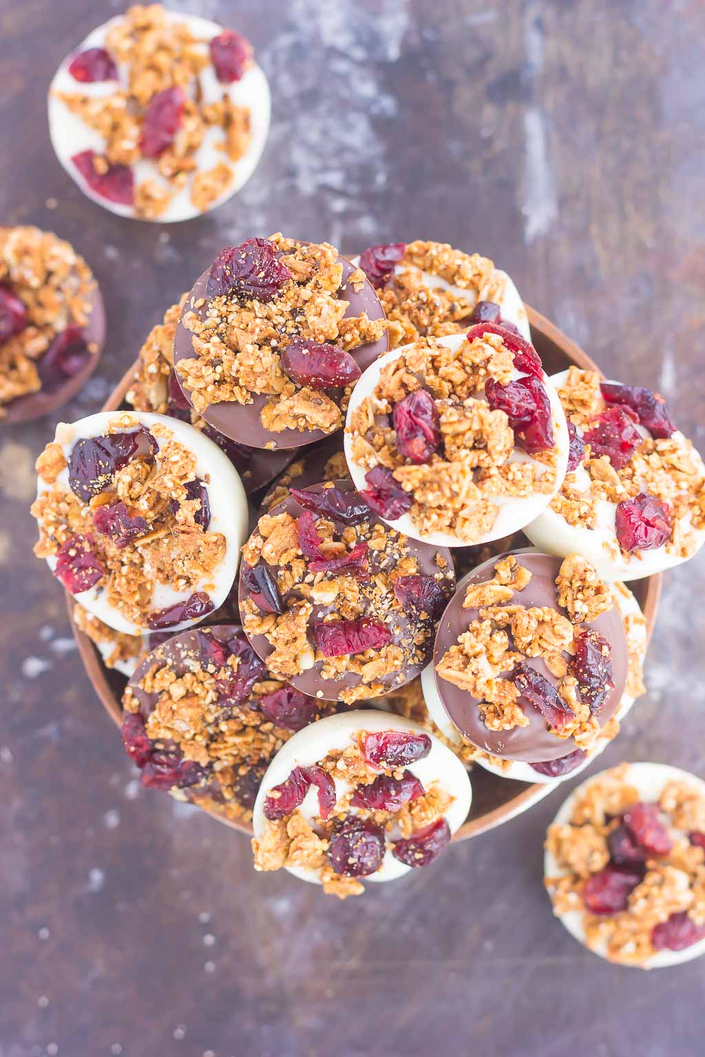 These Chocolate Cherry Granola Cups are the perfect bite for when you want something sweet. Smooth dark chocolate and creamy white chocolate cups are topped with crunchy granola and dried cherries. With no oven needed and ready in minutes, these cups make a delicious dessert or snack!