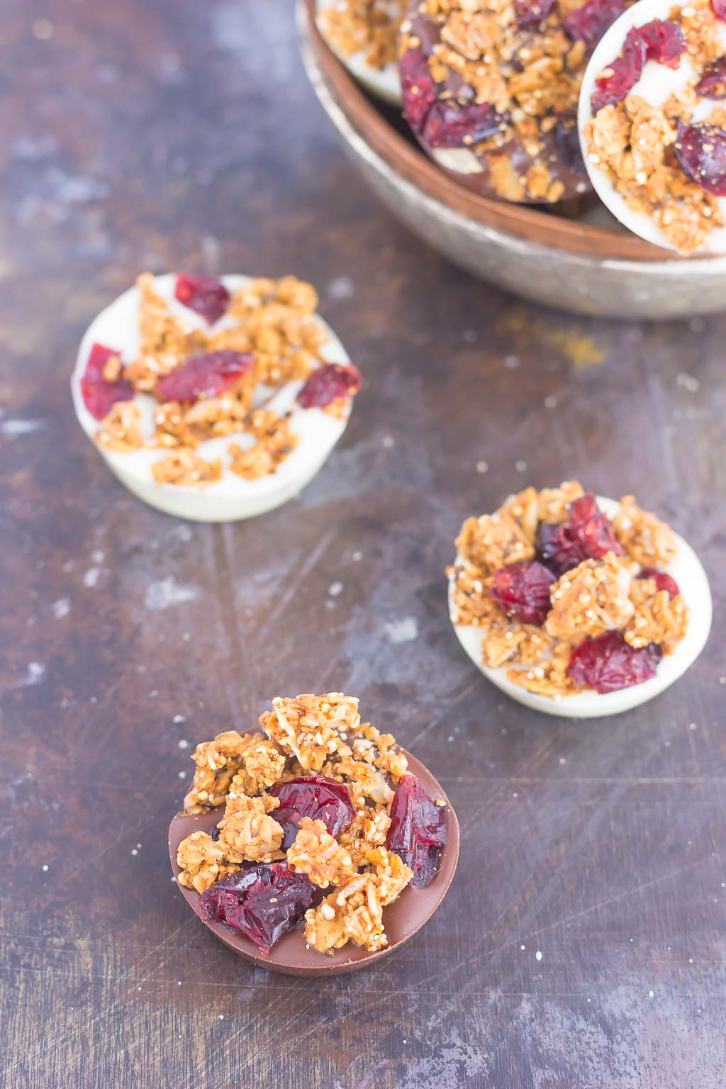 These Chocolate Cherry Granola Cups are the perfect bite for when you want something sweet. Smooth dark chocolate and creamy white chocolate cups are topped with crunchy granola and dried cherries. With no oven needed and ready in minutes, these cups make a delicious dessert or snack!