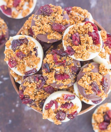 These Chocolate Cherry Granola Cups are the perfect bite for when you want something sweet. Smooth dark chocolate and creamy white chocolate cups are topped with crunchy granola and dried cherries. With no oven needed and ready in minutes, these cups make a delicious dessert or snack!
