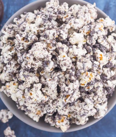 This Cookies and Cream Popcorn is an easy sweet treat that's ready in less than 10 minutes. Popcorn is coated with creamy white chocolate and then sprinkled with crushed Oreo cookies. Fast, easy, and perfect to munch on, this is the ultimate treat for when those snack attacks strike!