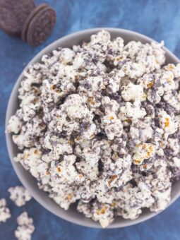 This Cookies and Cream Popcorn is an easy sweet treat that's ready in less than 10 minutes. Popcorn is coated with creamy white chocolate and then sprinkled with crushed Oreo cookies. Fast, easy, and perfect to munch on, this is the ultimate treat for when those snack attacks strike!