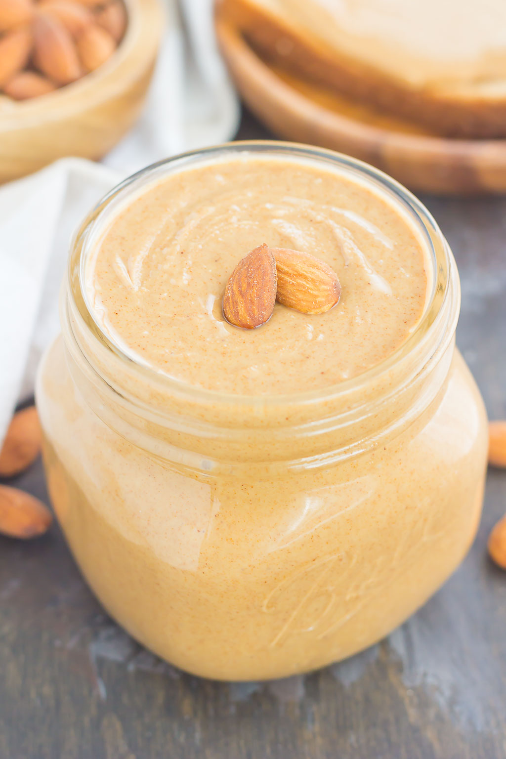 jar of homemade almond butter garnished with two almonds