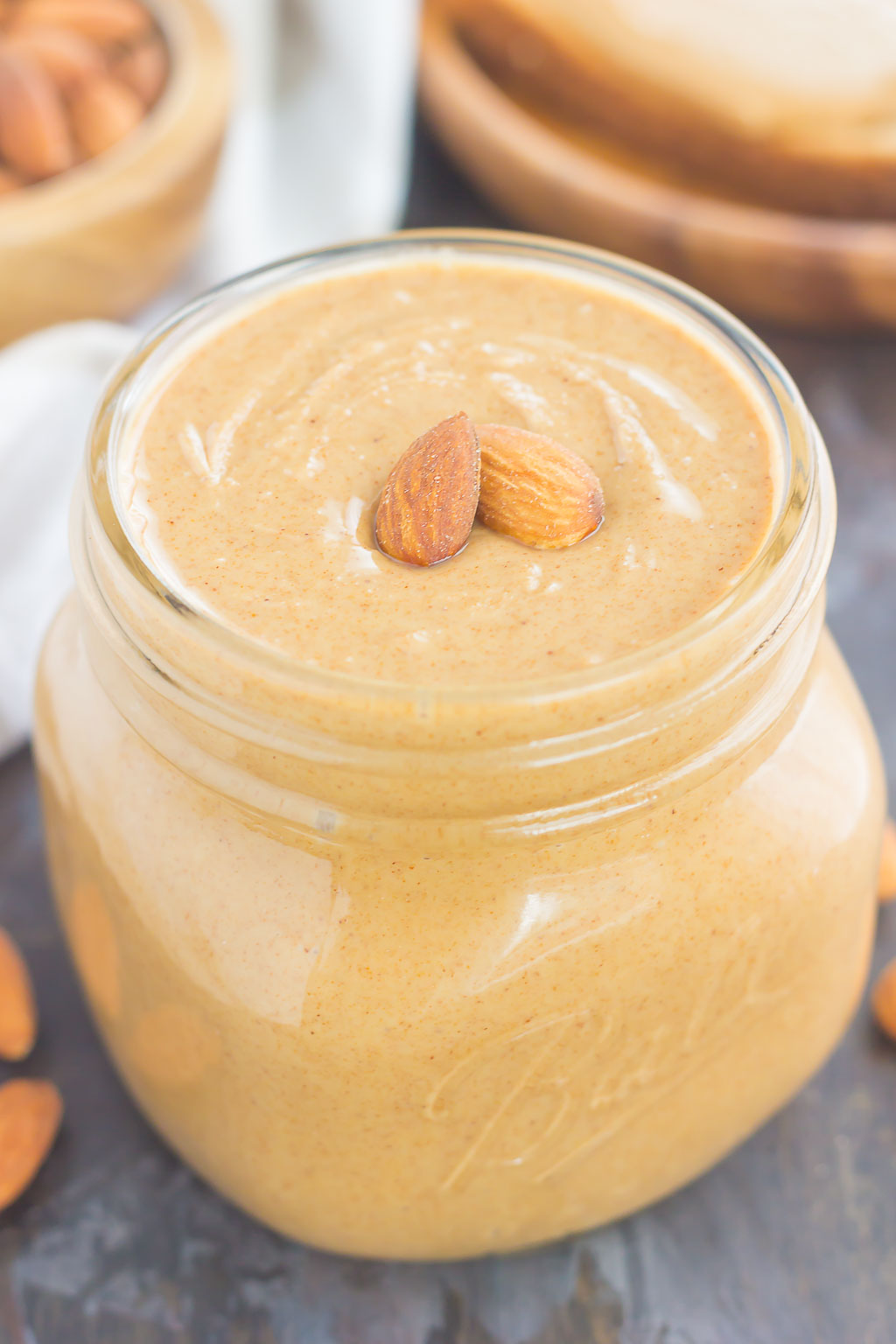 jar of the best almond butter garnished with two almonds