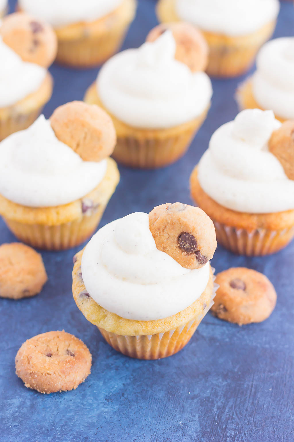 mini chocolate chip cupcakes on blue countertop 