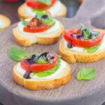 Caprese Bites make an easy appetizer that's ready in minutes. Fresh basil, mozzarella cheese, ripe tomatoes and a drizzle of balsamic glaze top toasted bread slices for the perfect bite. If you love caprese flavors, then this simple snack was made for you!