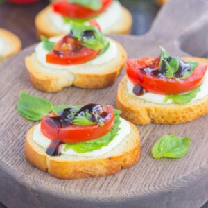 Caprese Bites make an easy appetizer that's ready in minutes. Fresh basil, mozzarella cheese, ripe tomatoes and a drizzle of balsamic glaze top toasted bread slices for the perfect bite. If you love caprese flavors, then this simple snack was made for you!