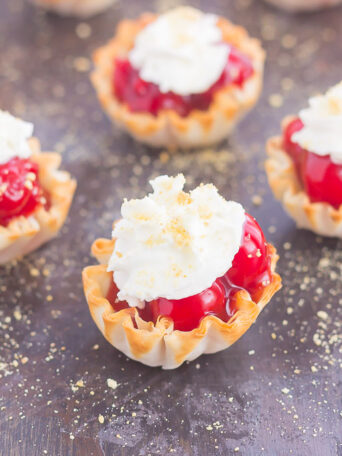 These Cherry Pie Bites are simple to make and bursting with the classic pie flavor. With just two ingredients and no oven required, you can have this mini treat ready to go for your parties or get-togethers. Top these bites with a dollop of whipped cream and crushed graham crackers and your easy dessert is ready to impress!