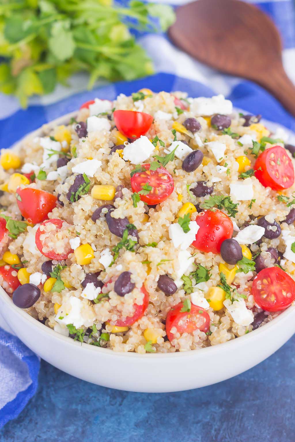 A large white bowl piled high with quinoa black bean corn salad. 