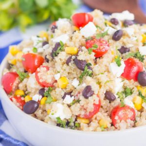 This Corn and Black Bean Quinoa Salad is hearty, on the healthier side, and perfect for a light meal. Quinoa is tossed with black beans, fresh corn, cilantro and tomatoes, and then tossed in a light white balsamic dressing. Loaded with flavor and ready in less than 30 minutes, this simple salad is perfect for lunch or dinner!