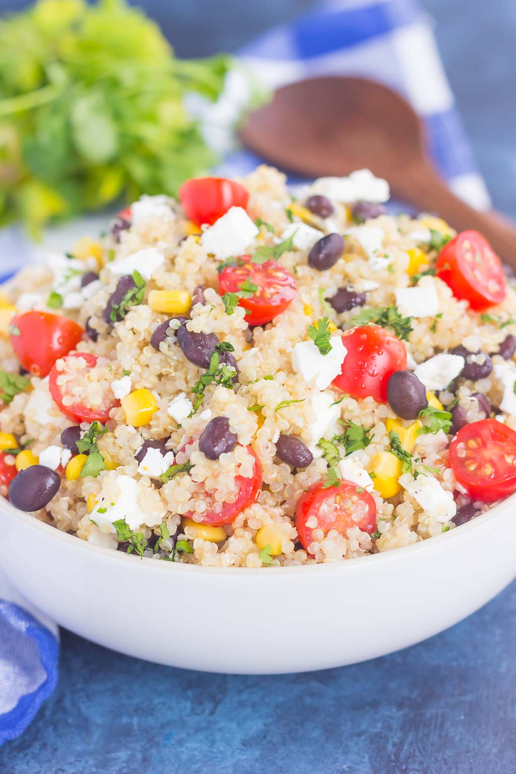 A white serving bowl of quinoa and black bean salad. 