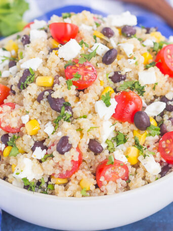 This Corn and Black Bean Quinoa Salad is hearty, on the healthier side, and perfect for a light meal. Quinoa is tossed with black beans, fresh corn, cilantro and tomatoes, and then tossed in a light white balsamic dressing. Loaded with flavor and ready in less than 30 minutes, this simple salad is perfect for lunch or dinner!