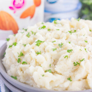 These Dairy-Free Garlic Mashed Potatoes are creamy, loaded with flavor, and made with no cream or butter. Tender potatoes are whipped to perfection and then sprinkled with seasonings and ready to serve. Easy to make and with simple ingredients, you'll never miss the dairy in this tasty side dish!