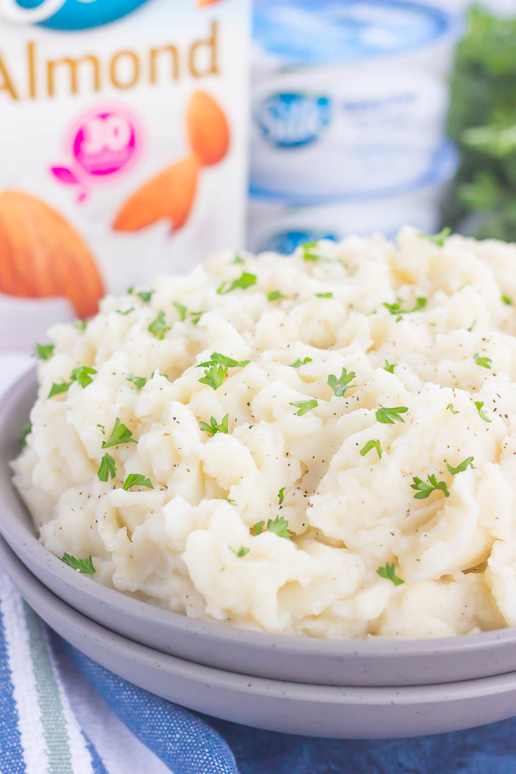 These Dairy-Free Garlic Mashed Potatoes are creamy, loaded with flavor, and made with no cream or butter. Tender potatoes are whipped to perfection and then sprinkled with seasonings and ready to serve. Easy to make and with simple ingredients, you'll never miss the dairy in this tasty side dish!