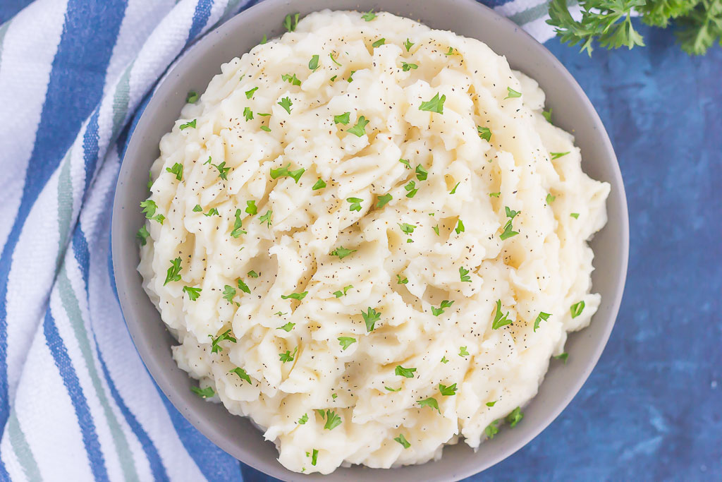 These Dairy-Free Garlic Mashed Potatoes are creamy, loaded with flavor, and made with no cream or butter. Tender potatoes are whipped to perfection and then sprinkled with seasonings and ready to serve. Easy to make and with simple ingredients, you'll never miss the dairy in this tasty side dish!
